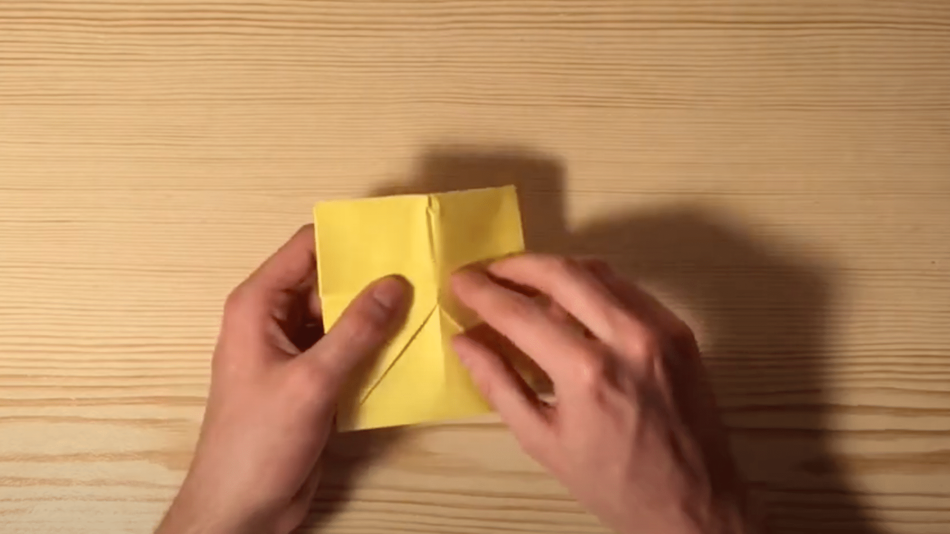 Grab_the_right_and_left_edges_of_your_paper_and_fold_the_entire_sides_into_the_center_line