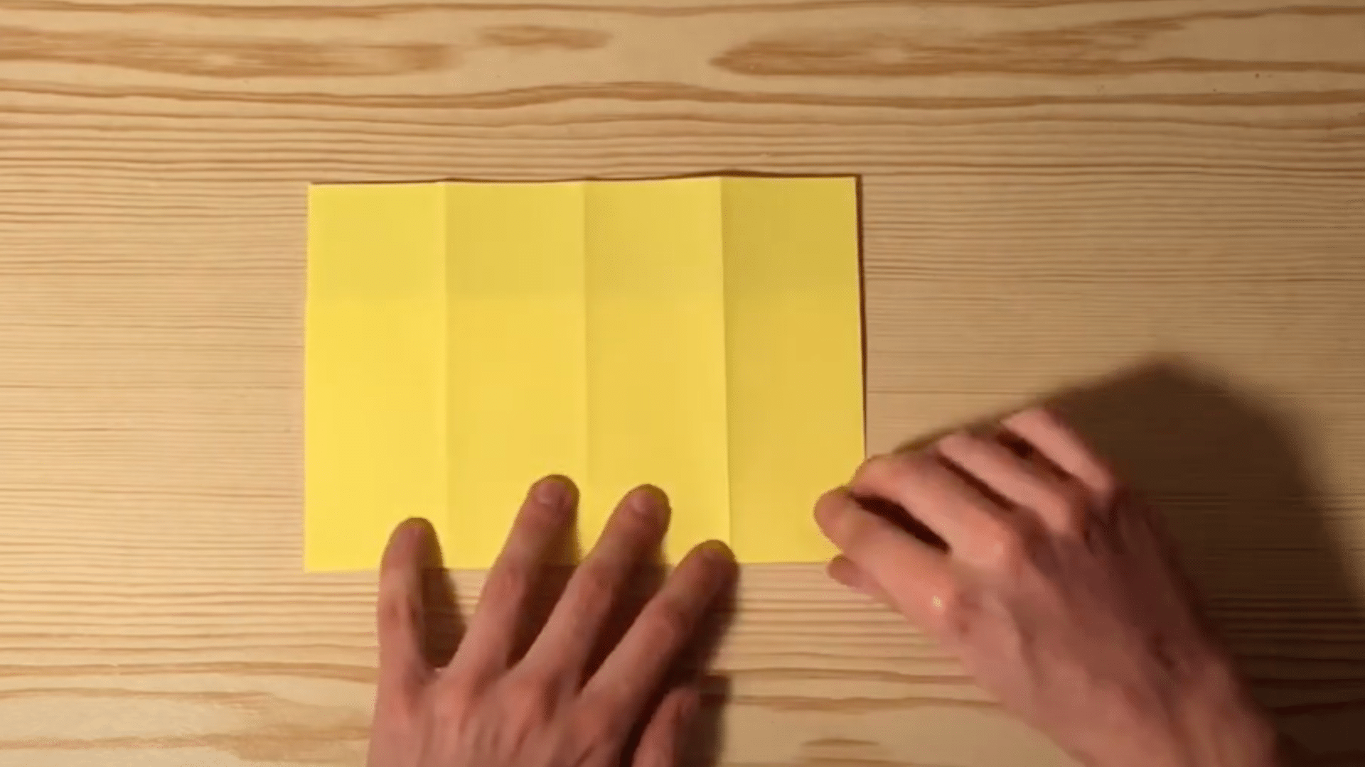 Take_just_the_top_layer_of_paper_and_fold_it_downward_about_one-third_of_the_entire_length